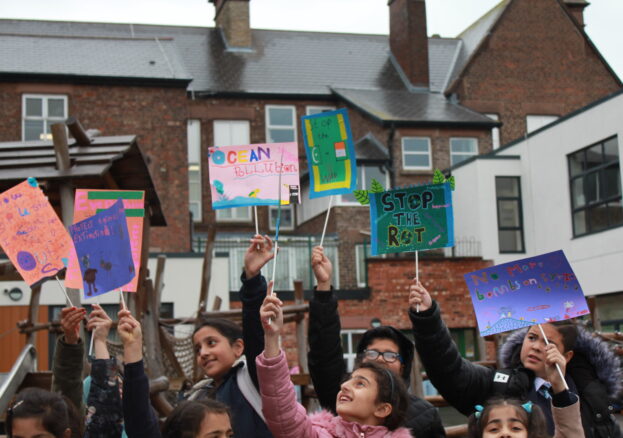 Children protesting with placards, made in a family workshop