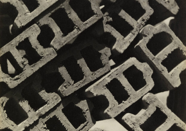 A black and white photograph of breezeblocks from above arranged to look like a street view from above