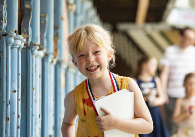 Grinning child on pool side