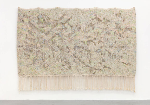 Large beige tapestry with intricate colourful beading hanging on a white wool