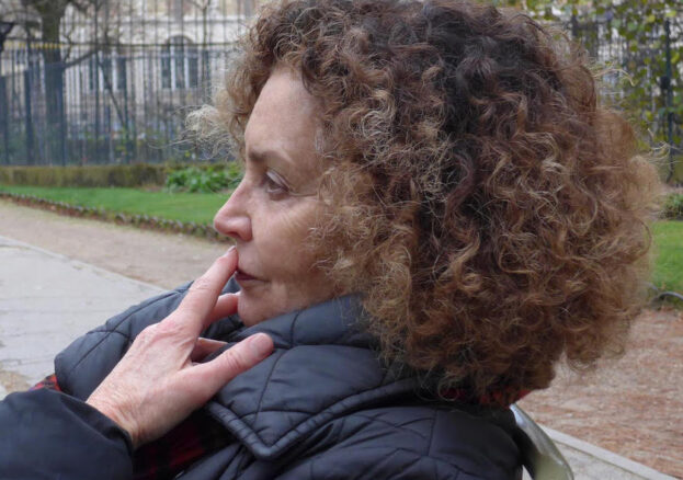 Photo of Beverley with brown curly hair and white skin in a black coat