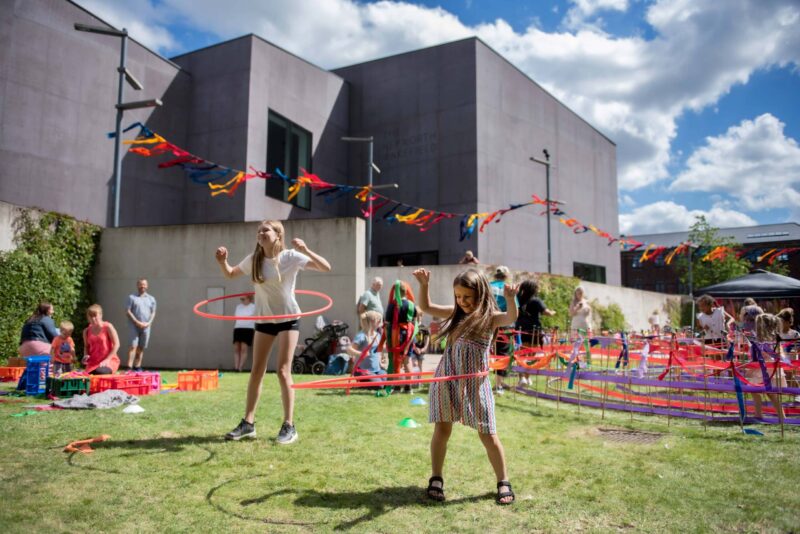 Two girls hula hooping outside The Hepworth Wakefield