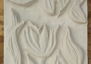 A plaster carving of flowers and leaves