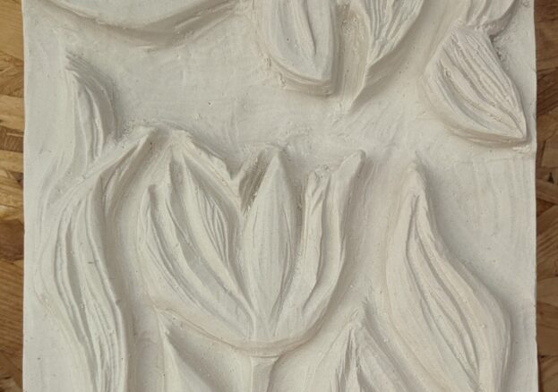 A plaster carving of flowers and leaves