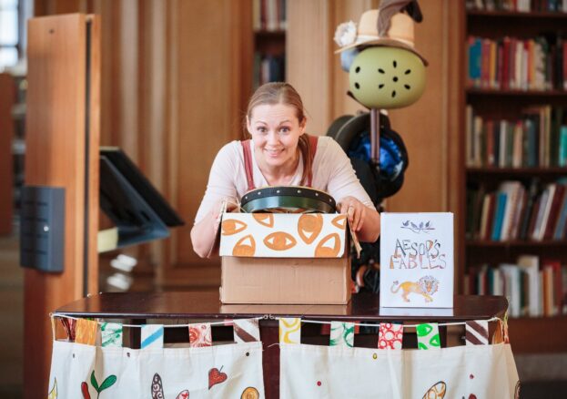 A photograph of Sophia Hatfield holding a box of props. Football Fairytales