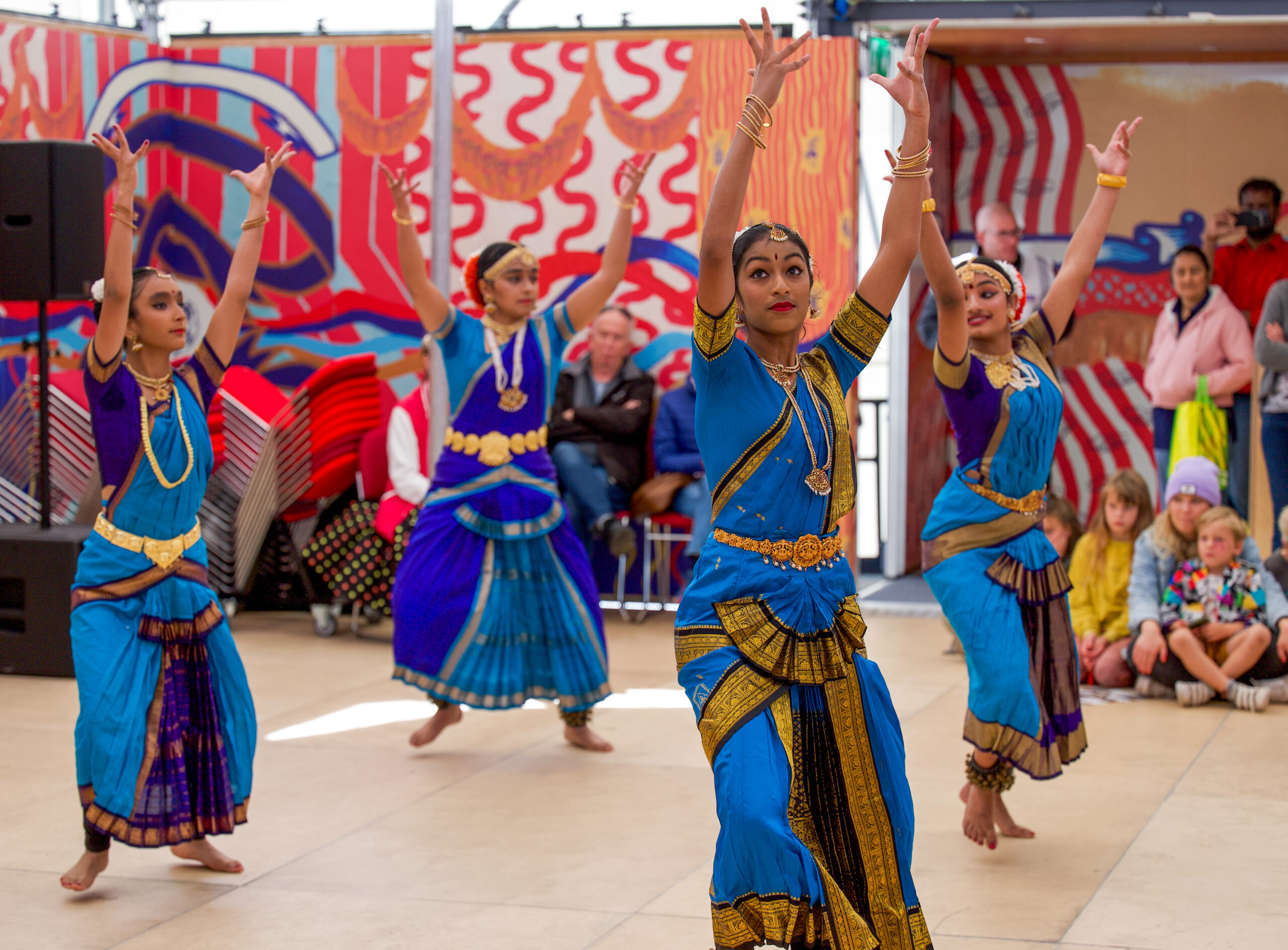 A traditional South Asian dance performance inside a mobile events space at Encounter Festival.