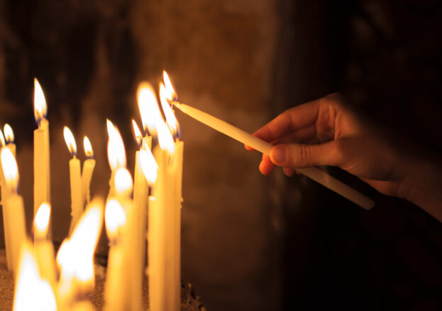 woman lighting candles in a church