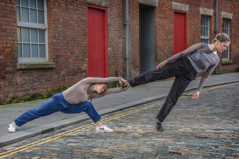 Dancers wearing casual clothes performing in street