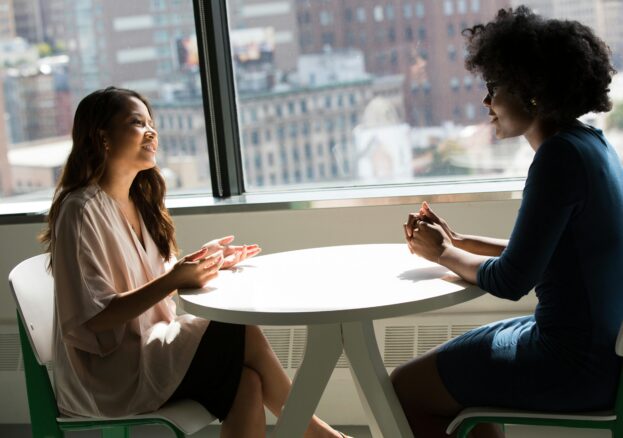 Two women chatting at a table