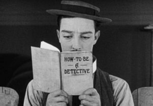 Man with moustache and bowler hat reading a book in front of face titled how to be a detective