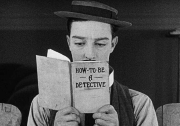 Man with moustache and bowler hat reading a book in front of face titled how to be a detective