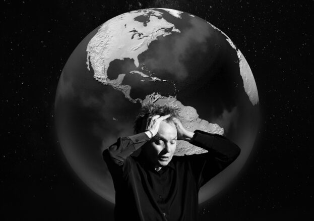 Factory International Autumn/ Winter Season at Aviva Studios : Artist Laurie Anderson holding her head in front of a giant globe