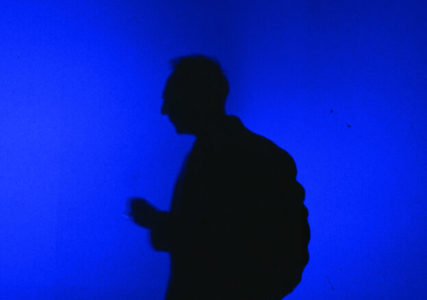 Blue Now at Aviva Studios: Silhoutte of a figure stood infront of a blue light.