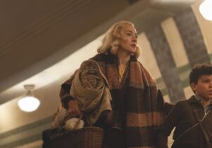 A mother and son walk in London's underground