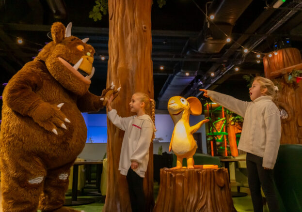 Children talking to a costume character at a family event