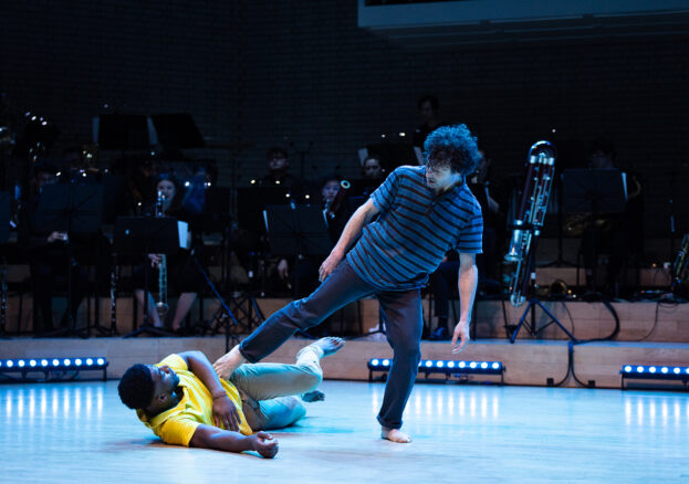 Two dancers and orchestra on stage