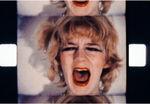 A film still, showing a woman's face screaming.